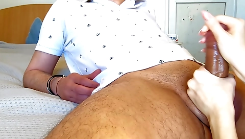 Amateur brunette girl gives a handjob to her big cock lover