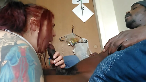 A hot redhead in a red bra is being fucked by a black man