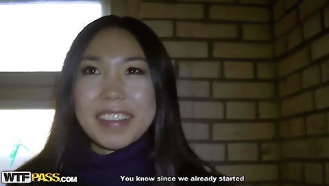 Asian brunette riding a guy's cock in an outdoor sex show